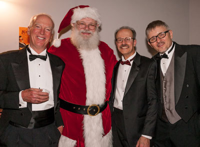 Gents in tuxes with Santa.