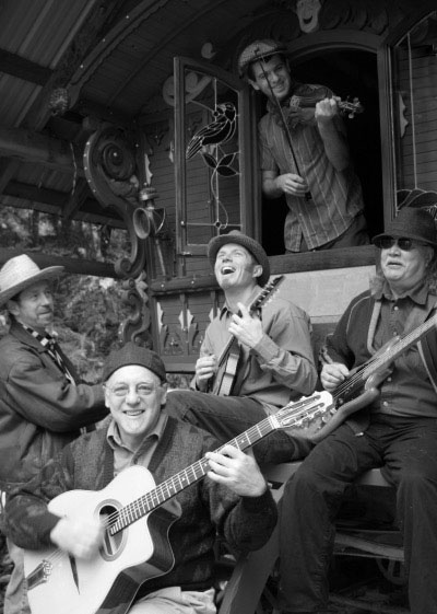 Ranger and the Re-Arrangers playing happily in what appears to be a gypsy wagon